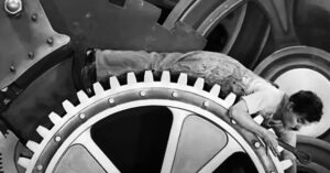 Charlie Chaplin inside the cogs of the machine from Modern Times